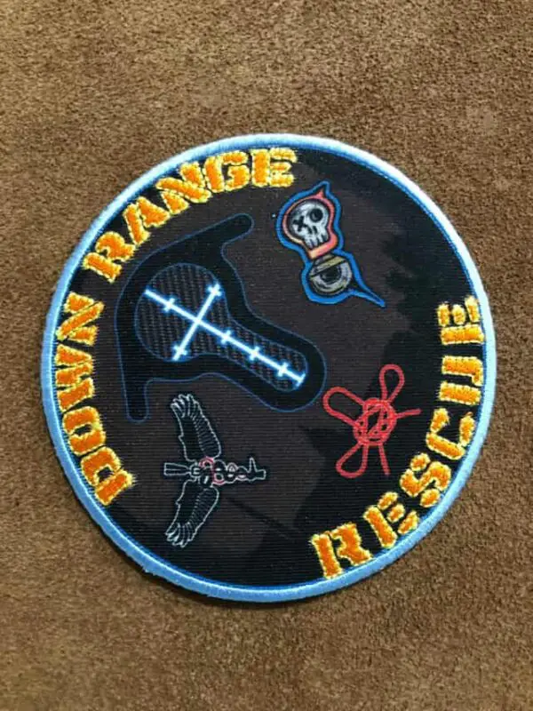 Circular patch with rescue-themed embroidery and the words 'Down Range Rescue'.