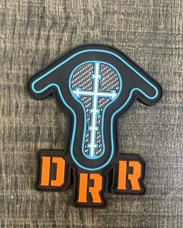 A patch with a thermometer design and letters "DRR" on wooden blocks.