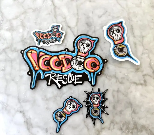 Colorful skull-themed stickers with 'Ice Ice Rescue' text on marble surface.